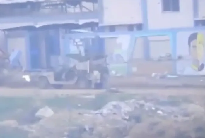 The area fills with heavy smoke. Burning metal, dust, and debris swallow everything in a gray shroud.