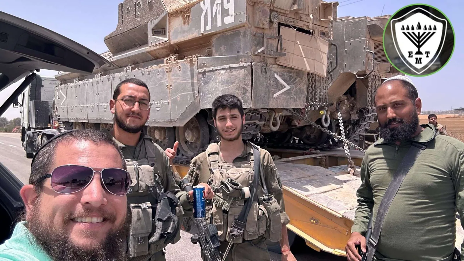 Volunteers at a transport stop with soldiers.